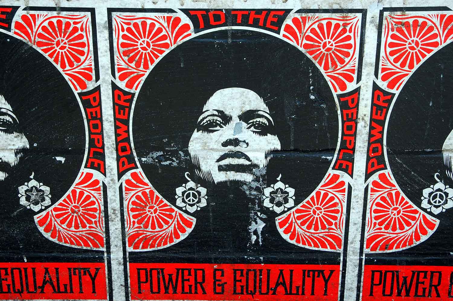 Poster depicting a woman wearing peace sign and star earrings. It also says 