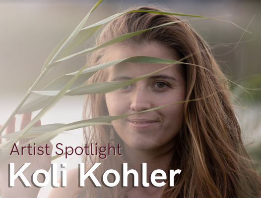 Koli Kohler stands in the sun with a leaf.