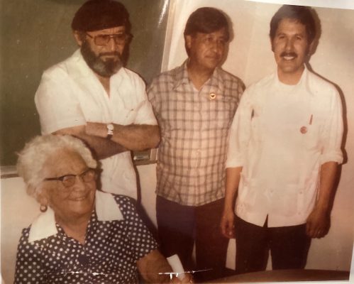 Cesar Chavez stands with friends, co-activists, and his mother.