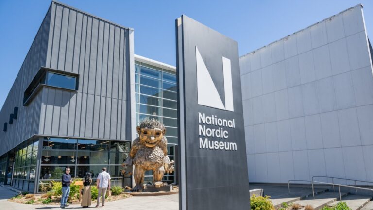 Exterior of the National Nordic Museum with a large troll statue in front.