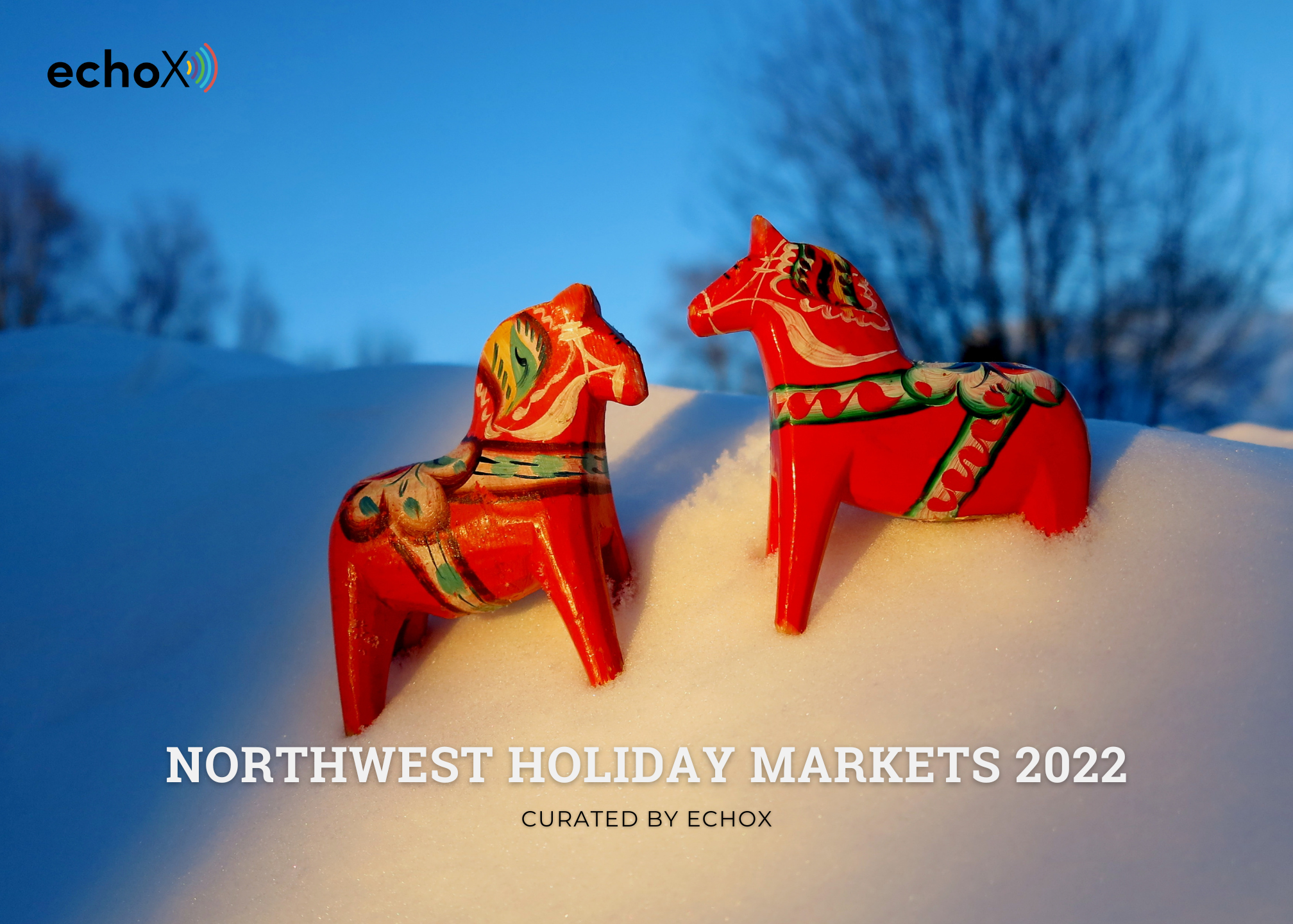 Two Dala horses stand on a mound of snow against a night sky.