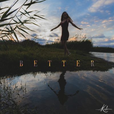Koli's album cover for better. In the shadows, a girl stands by the water, dancing.