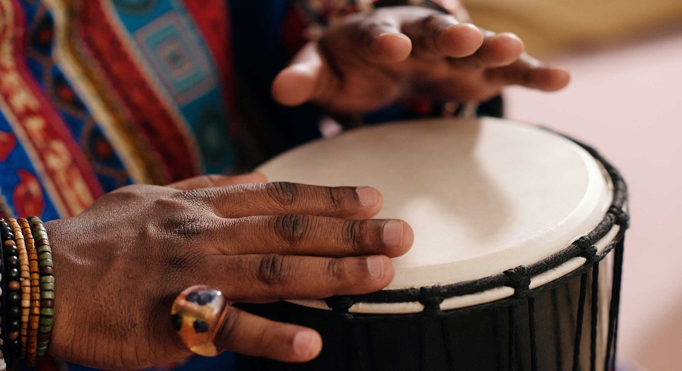 Person playing a traditional drum.
